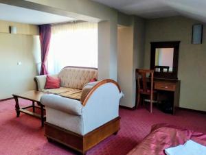 a living room with a couch and a table at hotel Sofia in Bansko