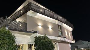 ein weißes Gebäude mit Lichtern an der Seite in der Unterkunft Hotel Marchina in Brescia