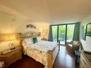 a bedroom with a bed and a large window at Paradise Found Cayo Hueso in Key West +55 photos
