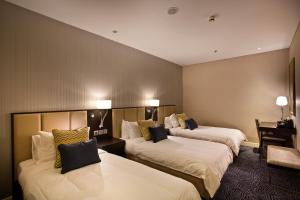 Uma cama ou camas num quarto em Ambassador Transit Hotel - Terminal 3