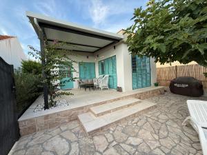 Beach House Ana في سوكوشان: منزل به فناء مظلل وطاولة