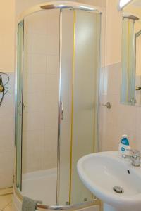 a bathroom with a shower and a sink at Apartamenty Klemens in Puck