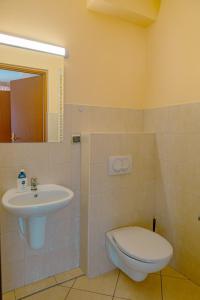 a bathroom with a toilet and a sink at Apartamenty Klemens in Puck +23 photos