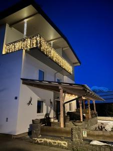 a white building with a lot of lights on it at Tyrolyl - Ferienhaus Tirol in Inzing
