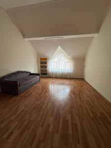 a bedroom with a bed and a wooden floor at Будинок на Духновича in Mukacheve