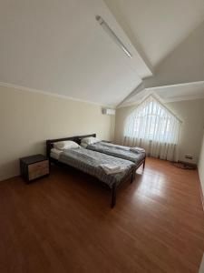 a large bedroom with a bed and a window at Будинок на Духновича in Mukacheve