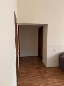 an empty room with a door and a wooden floor at Будинок на Духновича in Mukacheve