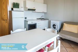 a small kitchen with a table and a couch at Appartamento a Senigallia sul mare - SE004 in Senigallia