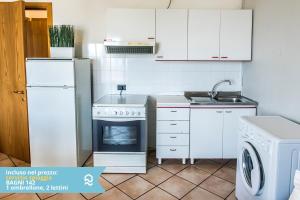a kitchen with a stove and a refrigerator and a dishwasher at Appartamento a Senigallia sul mare - SE004 in Senigallia +16 photos