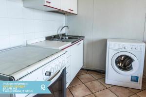 a kitchen with a sink and a washing machine at Appartamento a Senigallia sul mare - SE004 in Senigallia