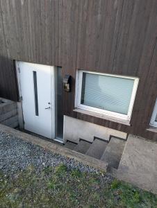 a door and a window next to a wooden wall at Haven Home in Stavanger +2 photos