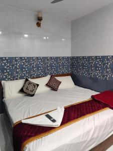 ein Bett mit Kissen darauf in einem Zimmer in der Unterkunft BMR home stay inn in Srikalahasti