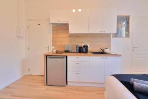 a kitchen with white cabinets and a counter top at SC4 - Studio 2e étage - Résidence Casino du Lac in Enghien-les-Bains