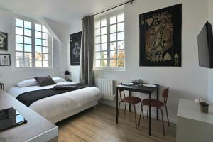 En eller flere senge i et værelse på SC4 - Studio 2e étage - Résidence Casino du Lac