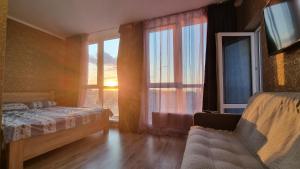 a bedroom with a bed and a large window at Ліфт, Вода, Опалення, WiFi працює завжди Видова Квартира, Позняки! in Kyiv