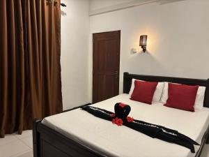 a bedroom with a bed with a bird on it at Shiny Villa in Unawatuna