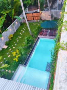 an overhead view of a swimming pool with an umbrella at Amarante Madiha in Matara