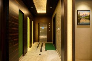 a hallway with a green mat in a building at Rooftop Sea View the KP Palace Near Jaganath temple - Restaurant # Lift and Free Parking Facilities # Fully Air Conditioning Hotel - Luxuary Hotel Prime Location in Puri +17 photos