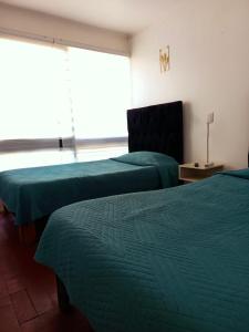 Ένα ή περισσότερα κρεβάτια σε δωμάτιο στο Hotel Rancagua, piezas simples dobles y familiares