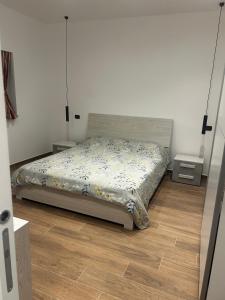 a bedroom with a bed and a wooden floor at La Dimora di Bacco in Sannicandro di Bari