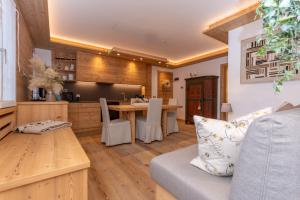 a kitchen and living room with a table and chairs at Alpine Nest in Rocca Pietore