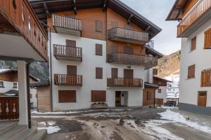 an apartment building with balconies and snow at Alpine Nest in Rocca Pietore