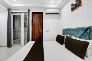 Ένα ή περισσότερα κρεβάτια σε δωμάτιο στο Hotel O RV Residency +21 φωτογραφίες