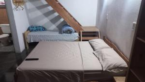 a small room with a bed and a staircase at La morocha in Camba Punta