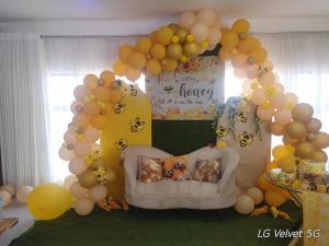 a birthday party with a balloon arch and a bed at Ocean View Road Villas in Amanzimtoti +18 photos