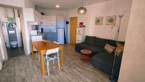 a living room and kitchen with a couch and a table at Apartamento Rosamar, sea view in Los Cristianos +26 photos