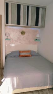 a bed in a bedroom with two lamps on the wall at Apartamento Rosamar, sea view in Los Cristianos