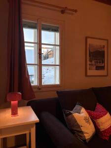 a living room with a couch and a window at Ferienhaus s'Mosern in Grundlsee +46 photos