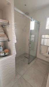 una ducha con puerta de cristal en un baño en Cosy Orchidée - Villa Élégance, Piscine & Pyrénées "5 étoiles", en Baigts-de-Béarn