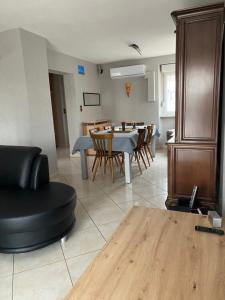 a living room and dining room with a table and chairs at La Maison des Pierres in Zinswiller