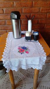 a table with a coffee maker on top of a table at Suítes portal do bosque in Visconde De Maua