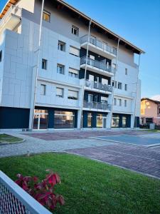 a large white building with a tennis court in front of it at Casa RoEz Bright studio apartment near ChorusLife and downtown in Bergamo