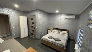 a small bedroom with a bed in a room at Family2 in Mukacheve