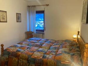 En eller flere senge i et værelse på Appartamento Casa Latemar