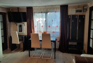 a dining room with a table and chairs and a window at Casa Crissio in Sinaia
