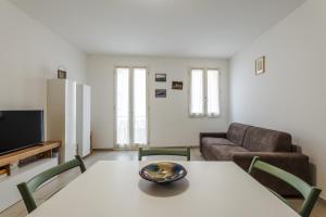 a living room with a table and a couch at FaCentro - Free WiFi & Air Conditioning in Faenza