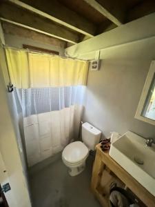 a bathroom with a toilet and a sink at Punta Negra - Cabañas Cacarelhos in Piriápolis +19 photos