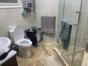 a bathroom with a toilet and a glass shower at Madinaty golden stay in Madinaty +15 photos
