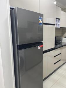 a stainless steel refrigerator in a kitchen at Madinaty golden stay in Madinaty