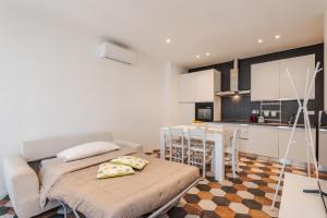 a kitchen and living room with a couch and a table at Ippolito - Free WiFi & Air Conditioning in Faenza