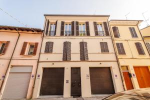 a building with two garage doors in front of it at Ippolito - Free WiFi & Air Conditioning in Faenza
