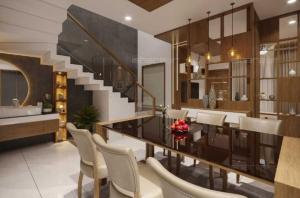 Un comedor con mesa y sillas y una escalera. en The Serenity Suites, en Trivandrum