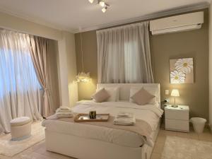 a bedroom with a large bed with a tray on it at Queen Nefertari-Luxury Apartment Near Pyramids Giza in Cairo