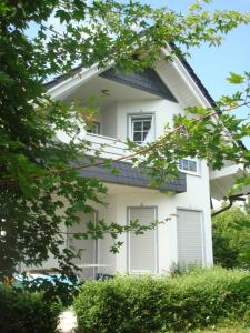 a white house with white windows and trees at Mein Sauerland in Medebach