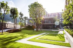 a rendering of a building with a green yard at Valley Mountain View&City Proximity Golden Eight Apartment in Ban Phlu Yai