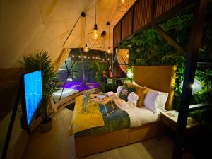 a room with a bed and a table in it at The Secret Garden Glamping Lancashire in Skelmersdale